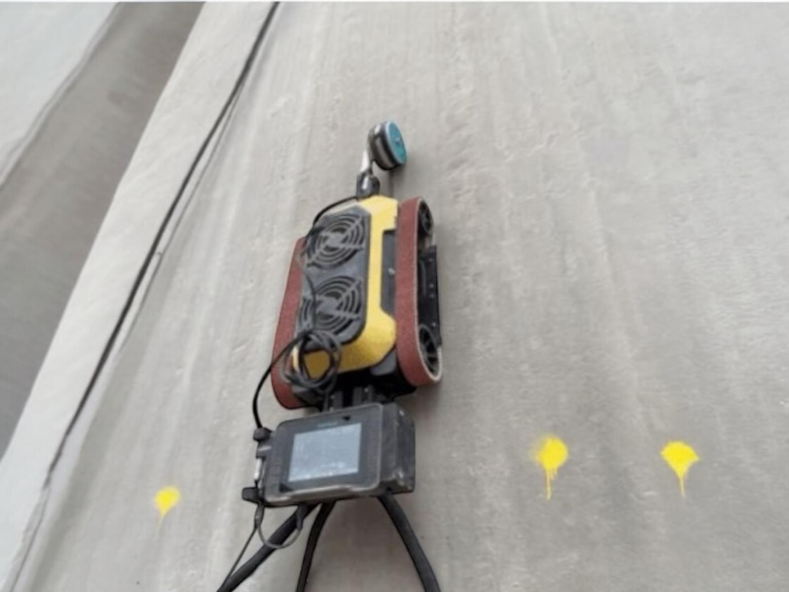 Structural Repairs' HB1 Wall Climbing Robot conducting concrete testing on 1960s cement silo